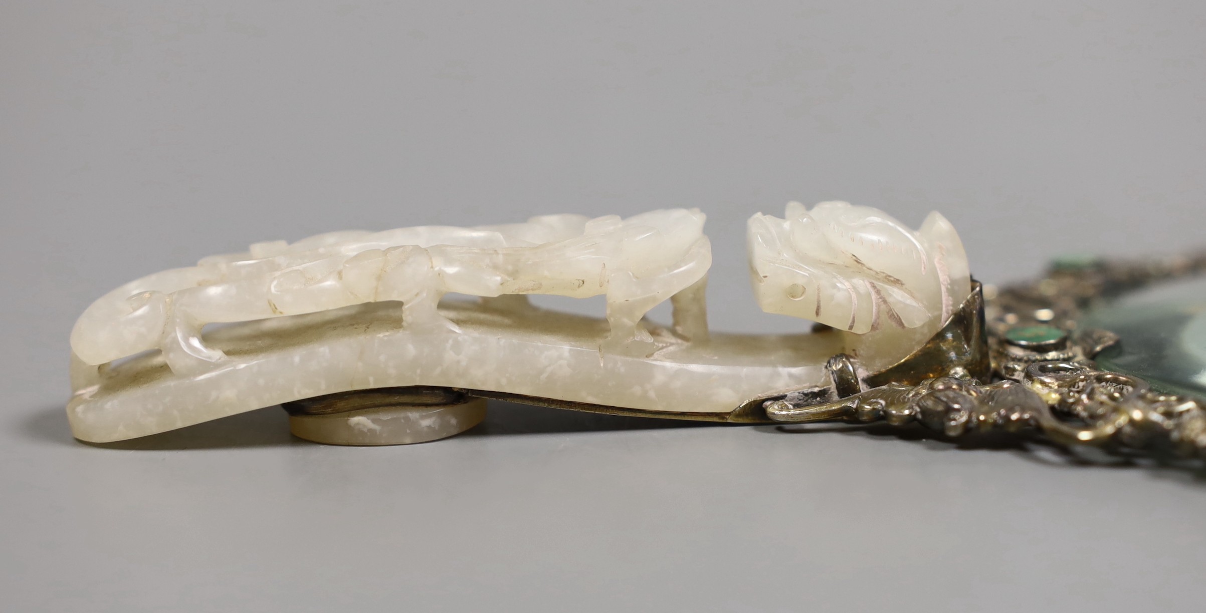 An Eastern white metal ‘SILVER’ marked magnifying glass with carved jade belt hook handle, total length 20cm